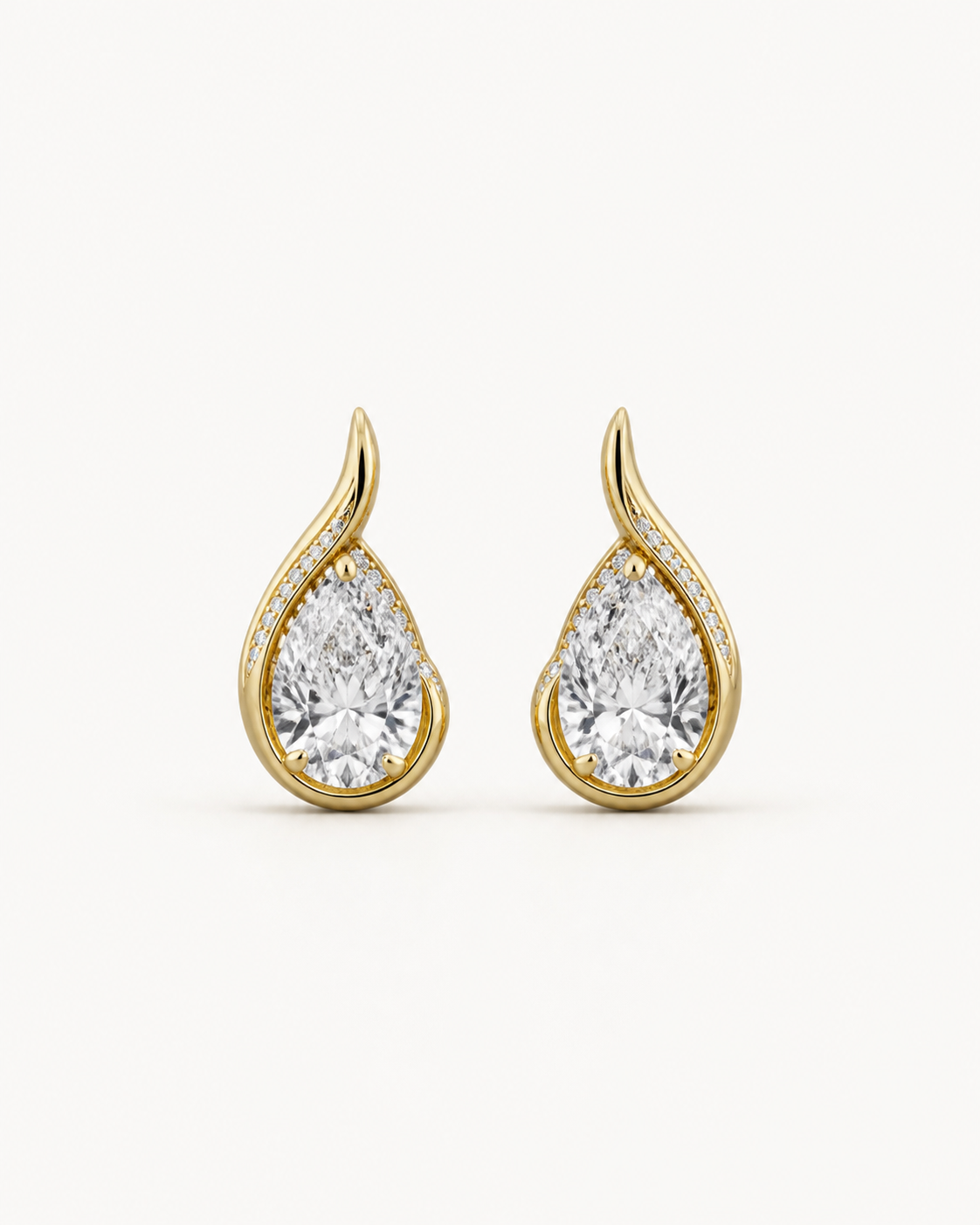 Warm-metal curved pear stud earrings on Oyster Silk.