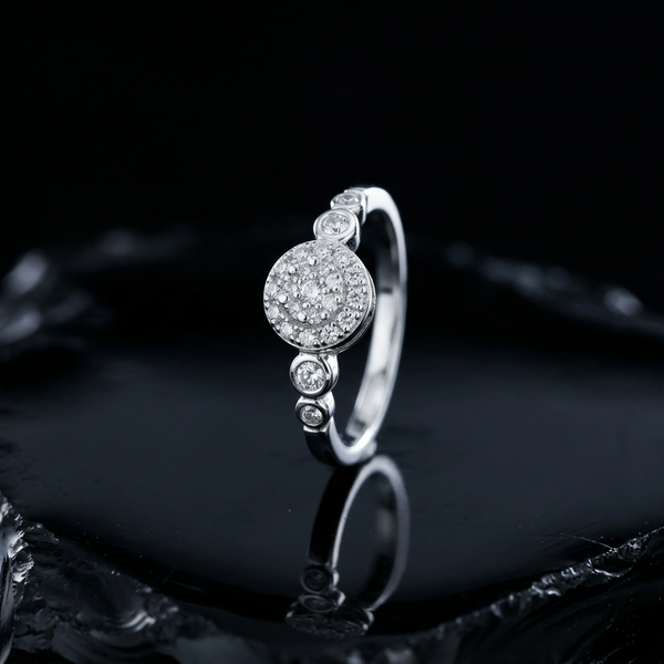 Silver pave cluster ring with graduated bezel settings, a secure setting for everyday diamond wear
