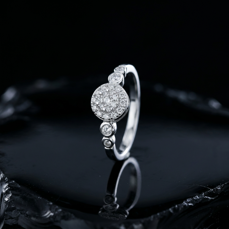 Silver pave cluster ring with graduated bezel settings, a secure setting for everyday diamond wear