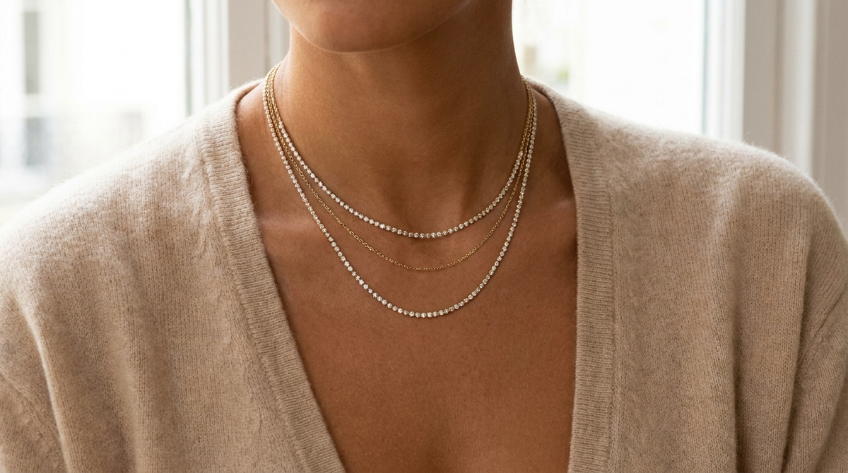 Three layered fine diamond necklaces of varying lengths worn at the neckline