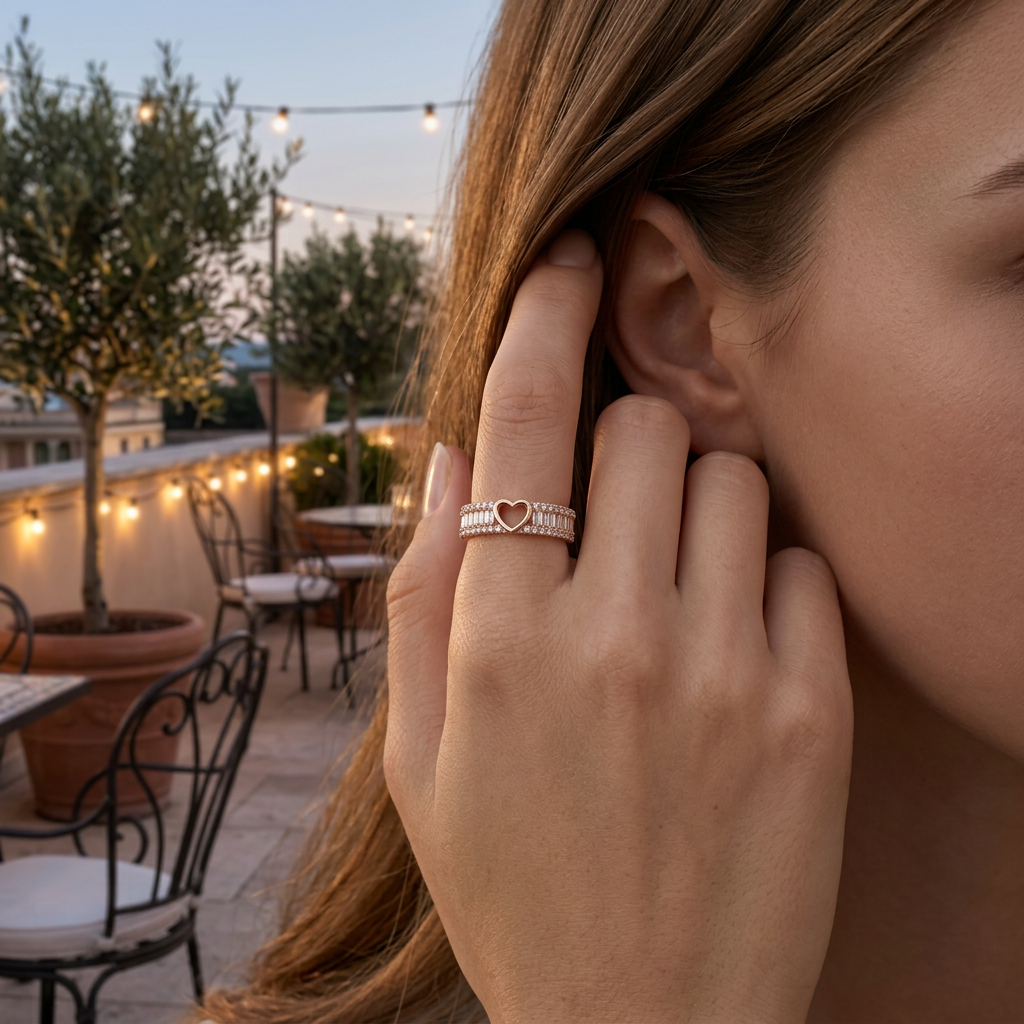 Editorial shot of a model wearing an architectural rose gold band featuring a central pavé-lined heart motif.