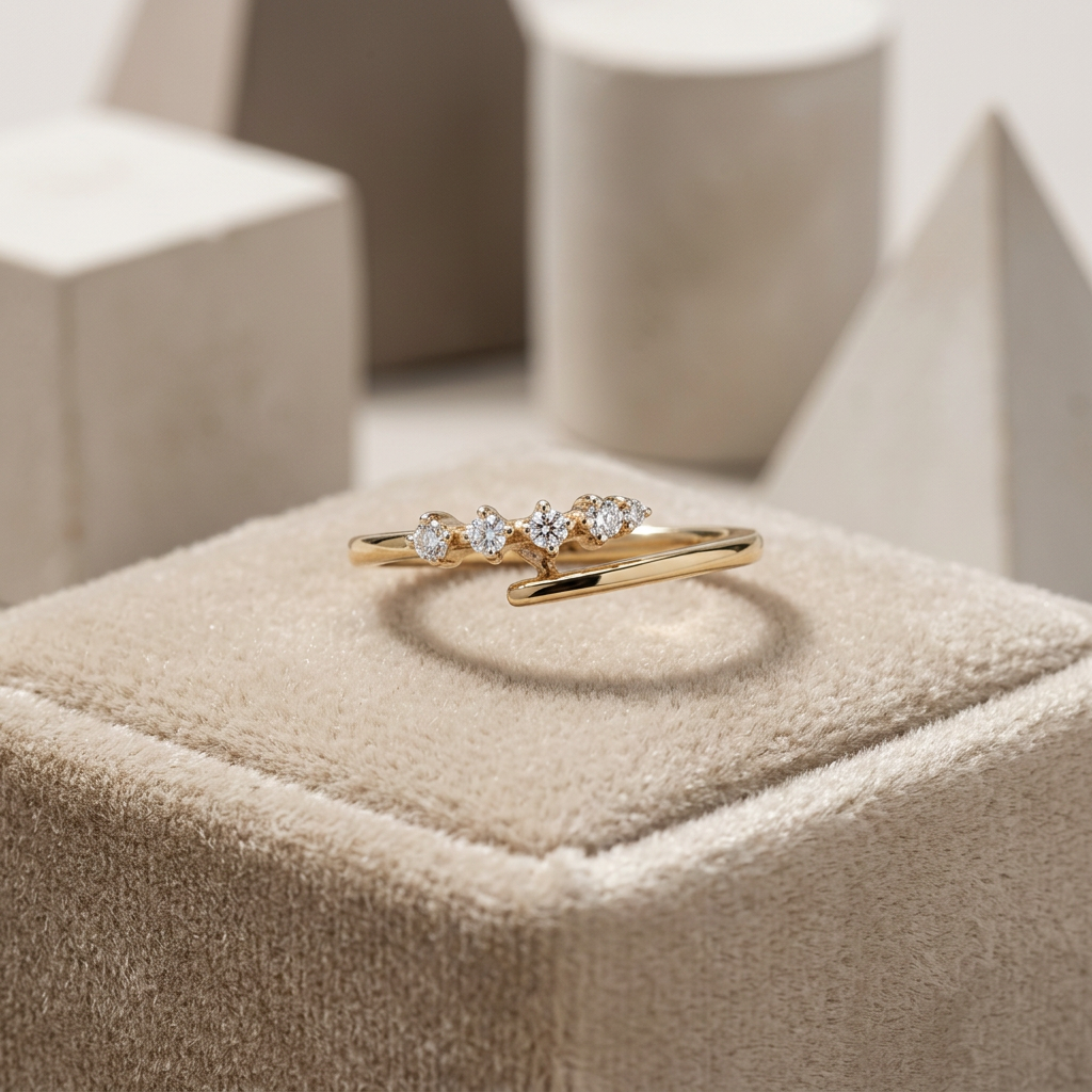Fluid rose gold open ring featuring a high-polish bypass silhouette accented by four graduated round diamonds.