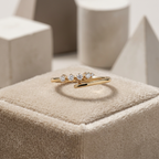 Fluid rose gold open ring featuring a high-polish bypass silhouette accented by four graduated round diamonds.