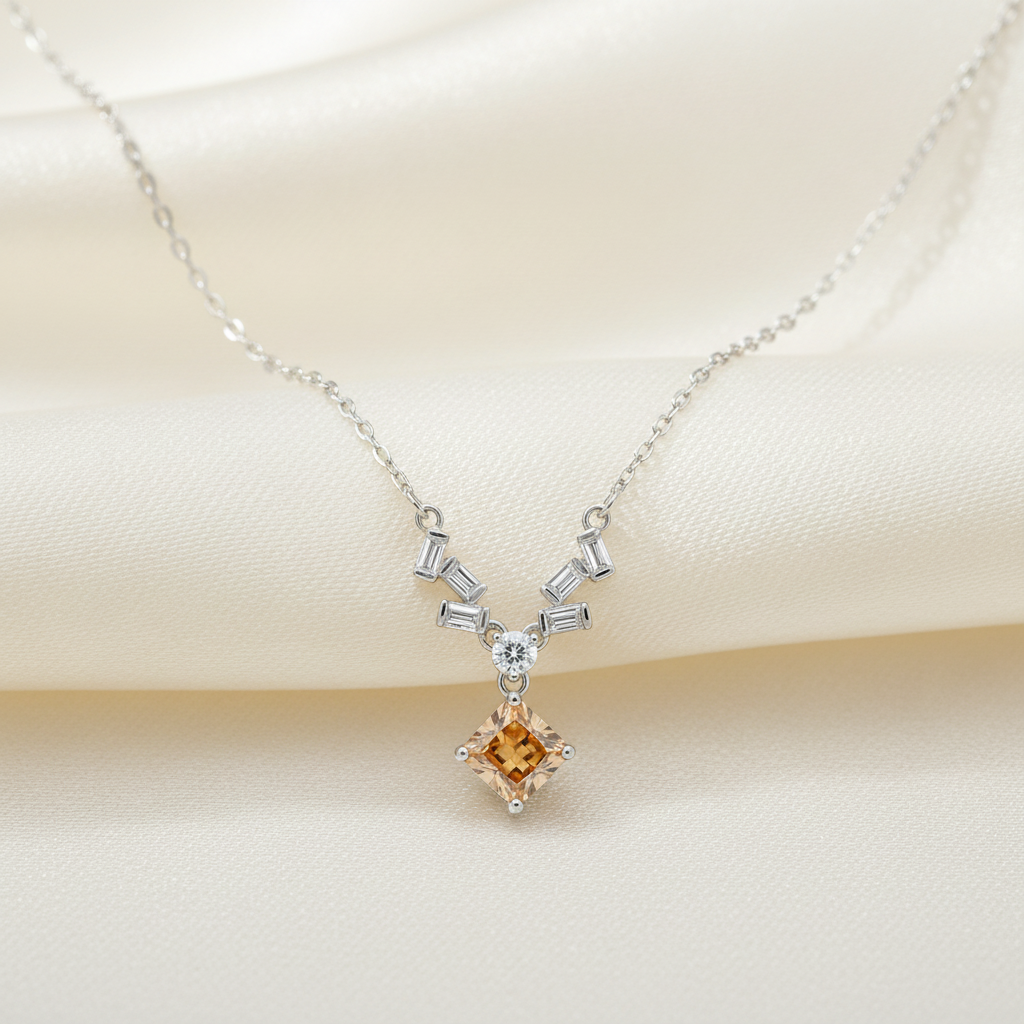 Sculptural baguette accents framing a honeyed lozenge-cut gemstone on a refined polished silver necklace for women.