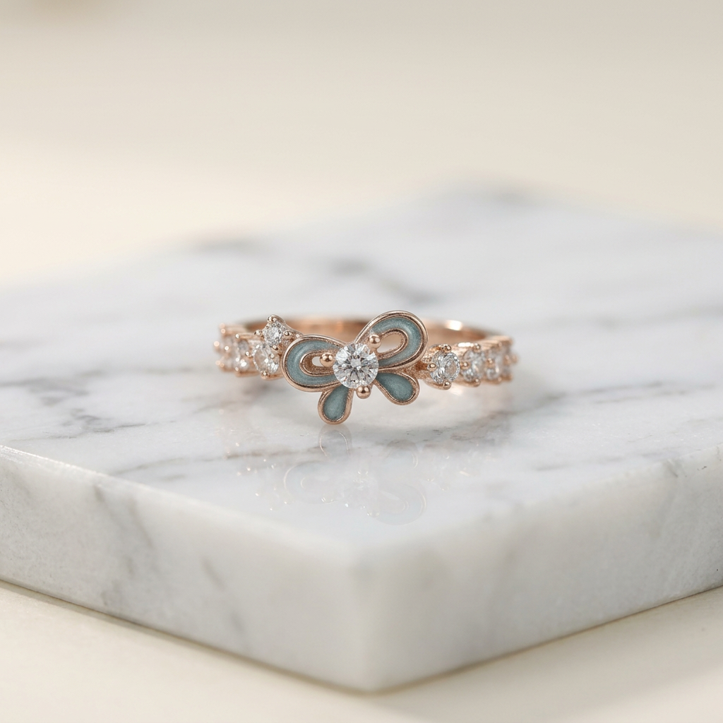 A polished yellow gold ring shaped like a fluid ribbon, featuring a vibrant cerulean blue center stone.