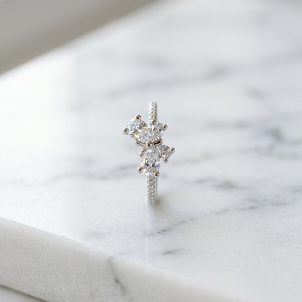 A magnificent cluster ring showcasing a sculptural, symmetrical butterfly motif intricately crafted with light-reflecting pear and round cut lab grown diamonds.