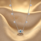 A detailed macro view of an evil eye necklace featuring a vibrant blue cerulean iris surrounded by brilliant pavé stones.