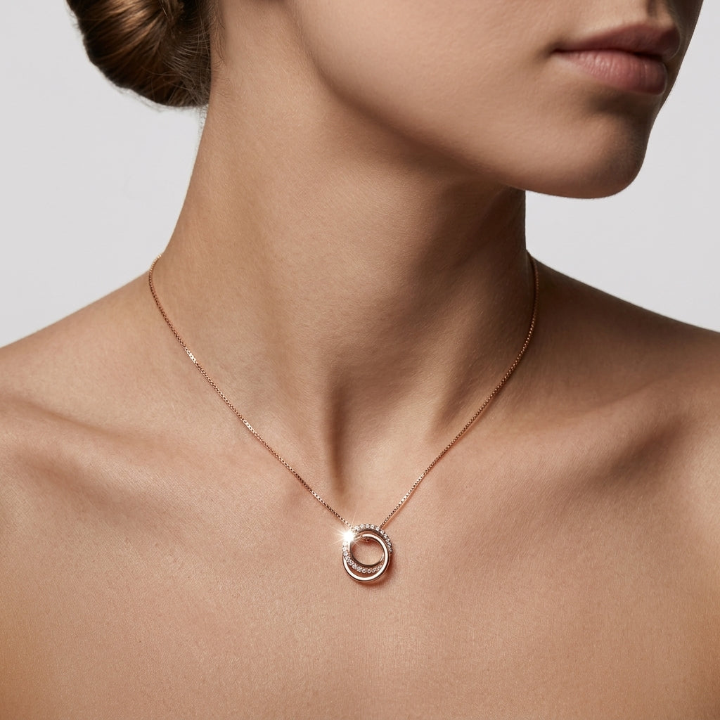 Detailed shot of precision pavé settings contrasting against polished rose gold bands on a geometric link pendant.