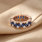 White gold variation of the eternity band balancing deep blue marquise stones and icy round accents.