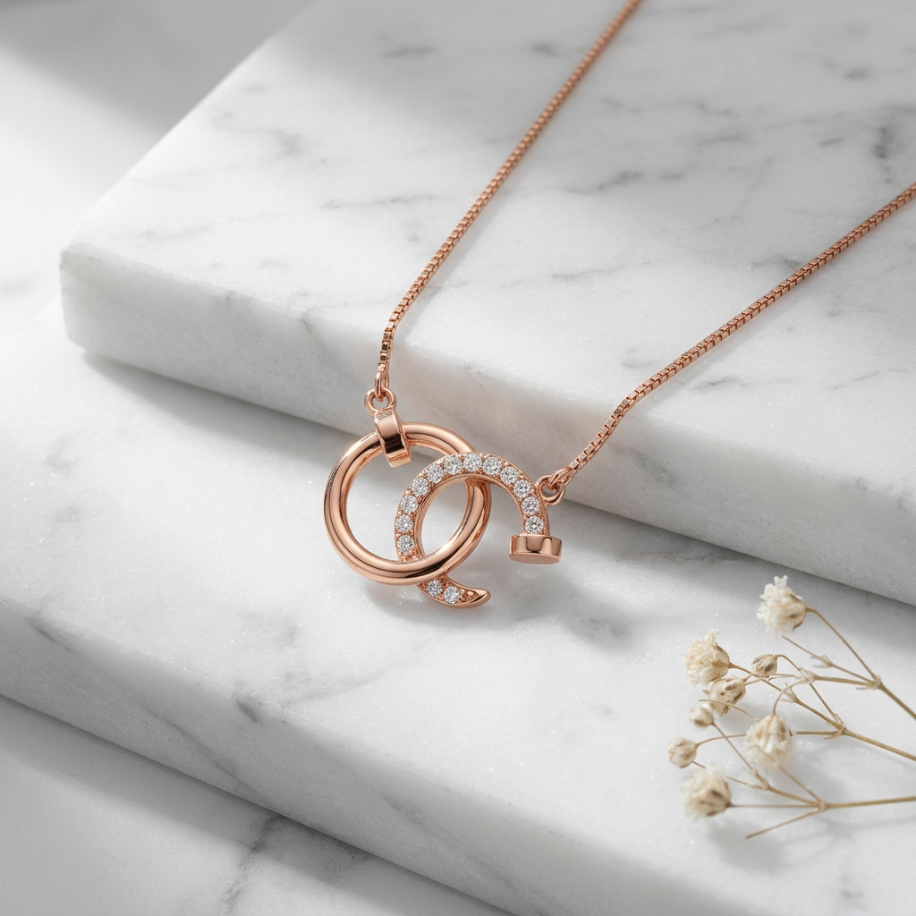 Sculptural rose gold round pendant featuring interlocking industrial circles and a shimmering pavé-accented silhouette.