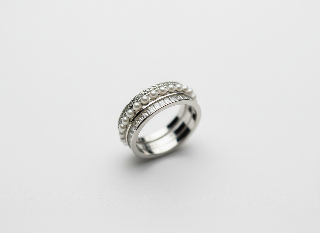 A luxury multi-band hand stack anchoring a triple layer sterling silver layered ring with slim modern silver jewelry.