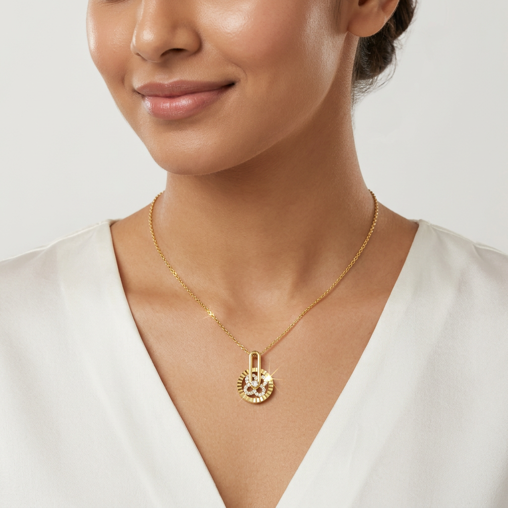 A dainty gold medallion necklace with an elongated link chain styled gracefully on a woman for effortless luxury.