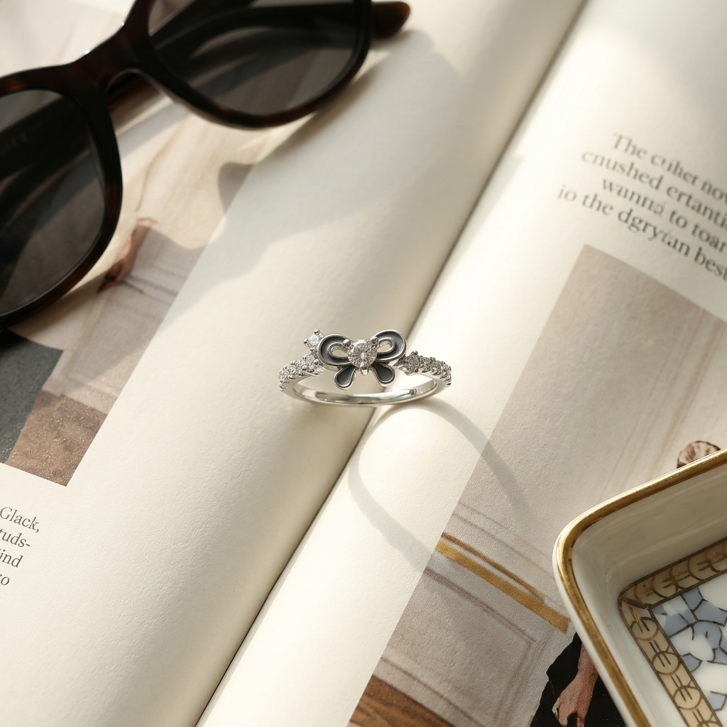 Macro photo focusing on the deep slate black enamel bow centerpiece accented by shimmering brilliant cut stones.