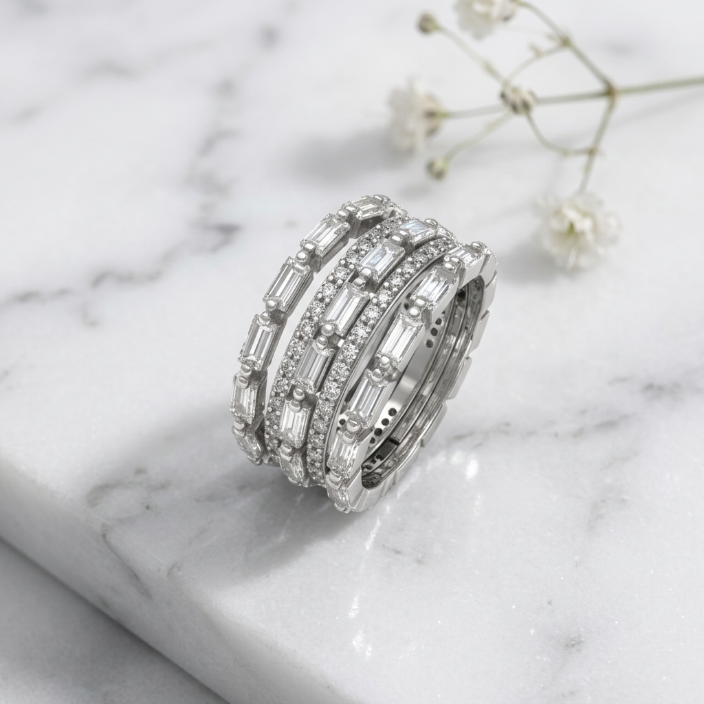 Macro photo focusing on the alternating sharp baguette cuts and round diamonds on a white gold tiered ring.