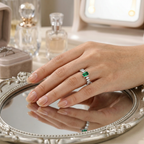 Close-up of a model wearing a forest green emerald ring showcasing its sharp geometric lines and rich hue.