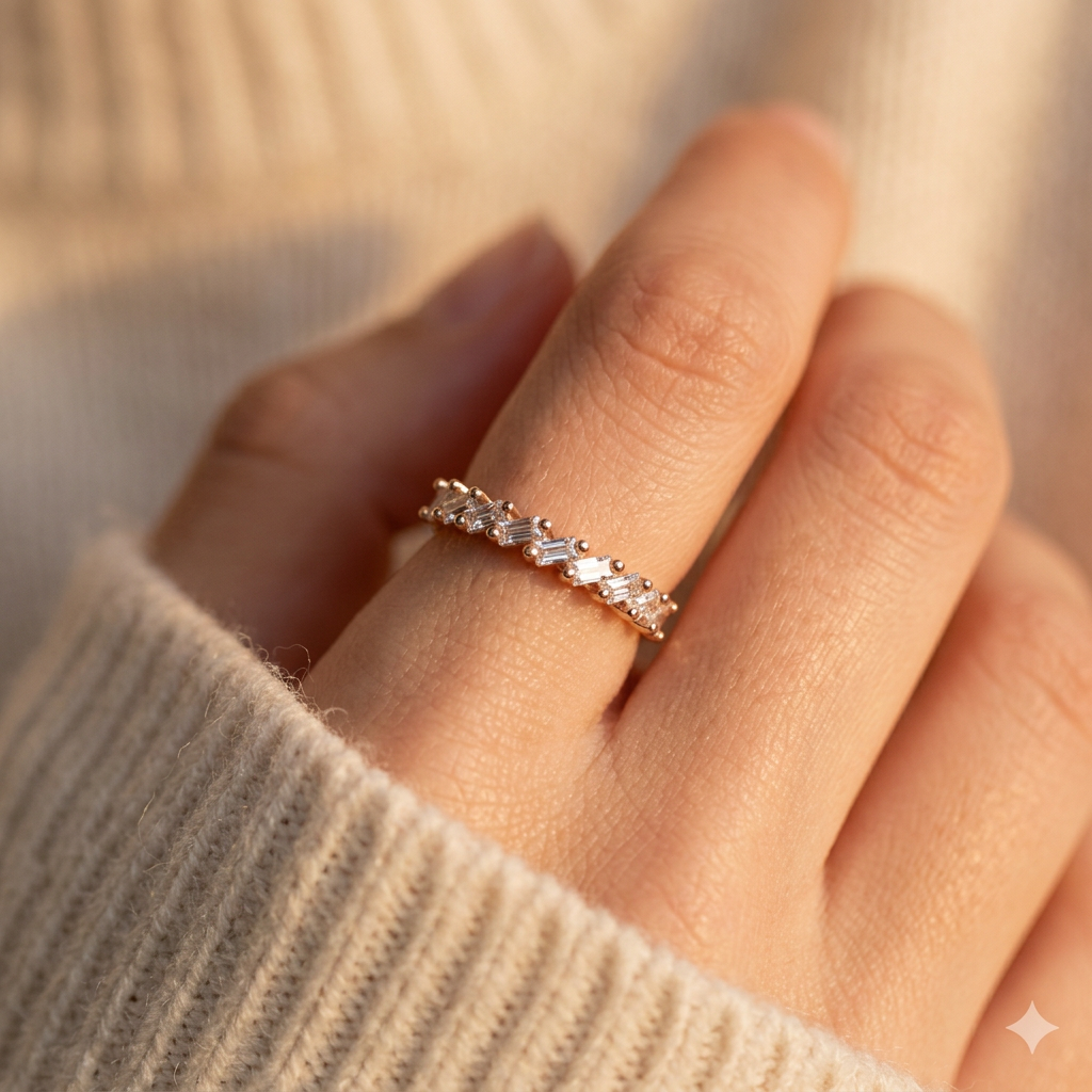 Close-up of a model wearing a fine rose gold baguette ring with geometric textures for a modern statement look.