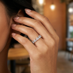 Close-up of a model wearing an architectural silver chevron ring showcasing its modern geometric silhouette.