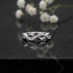 Silver diamond infinity ring showing interlaced bands set with brilliant delicate pavé stones.