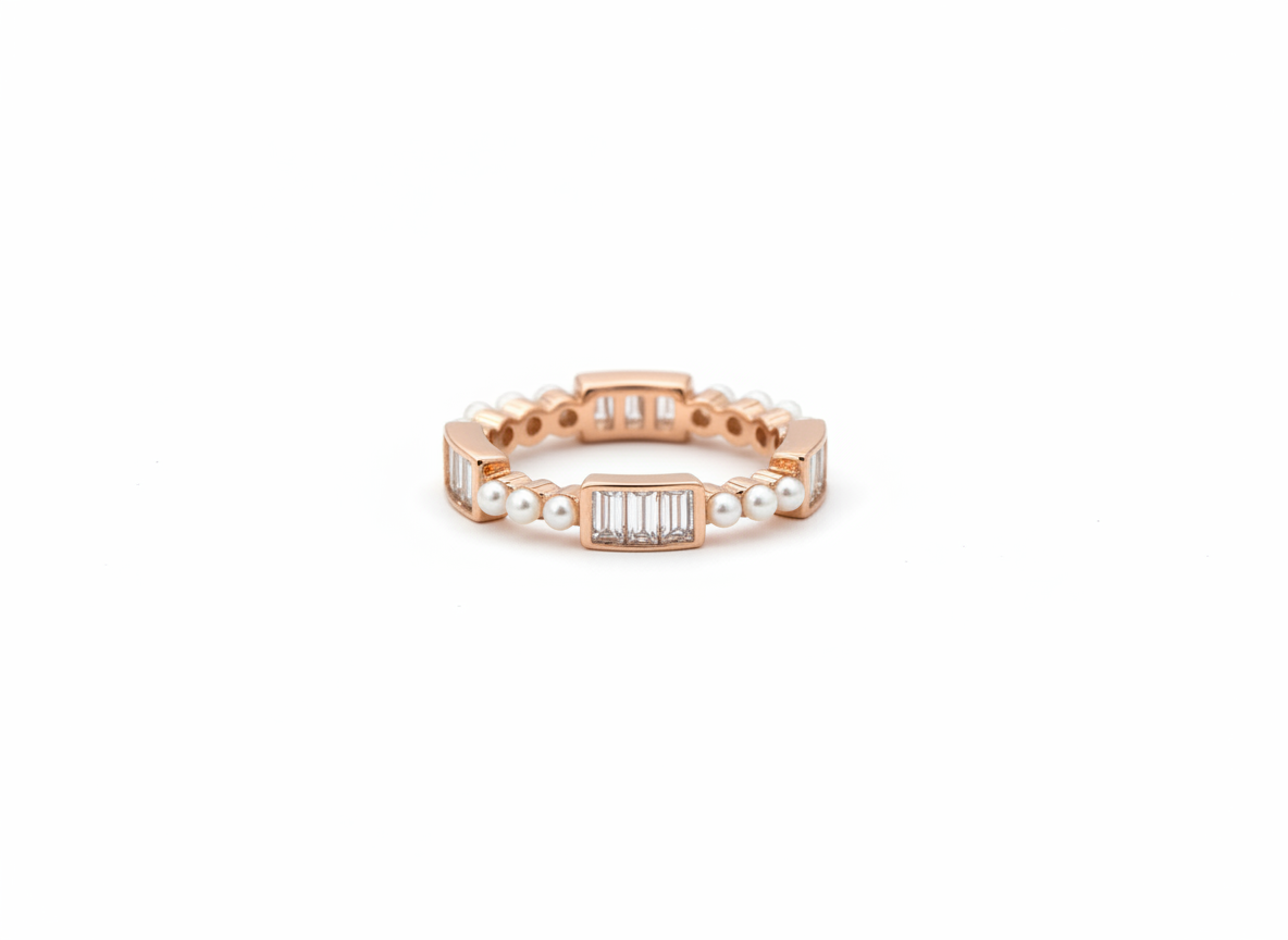 Editorial view of a model wearing a rose gold eternity band crafted with seed pearls and baguette diamonds.