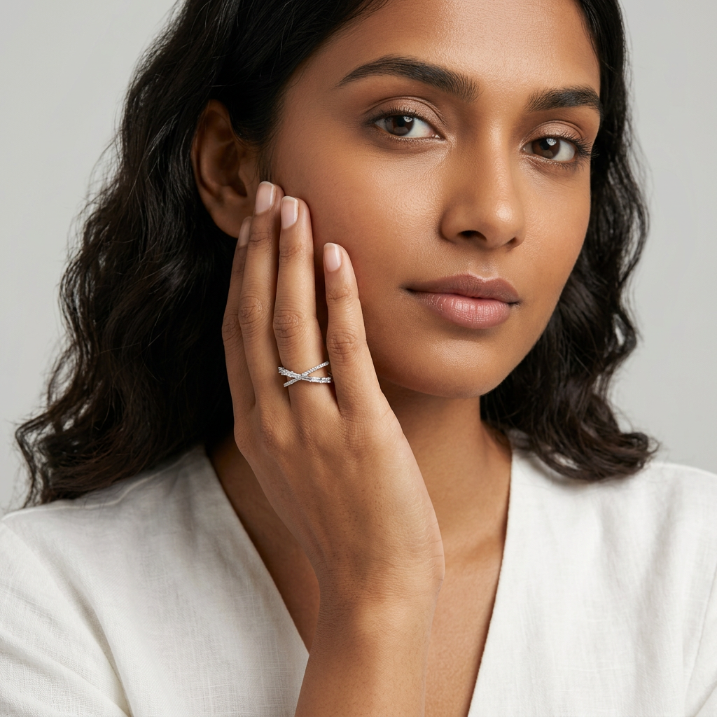 A luxury multi-band finger stack anchored by a dual textured silver crossover ring alongside slim accent bands.