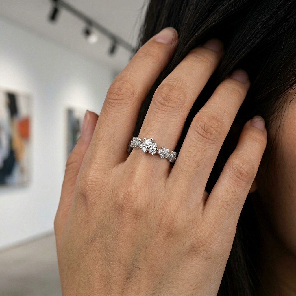 A contemporary luxury hand stack anchoring a wide sculptural crystal cluster ring with slim high-polish bands.