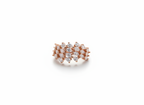 Studio flat lay of an organic rose gold botanical cluster ring resting cleanly on a smooth marble surface plate.