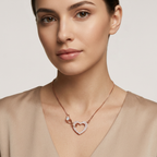 Side view of a fine rose gold infinity heart necklace charm capturing the light reflecting off its solitary round stone.