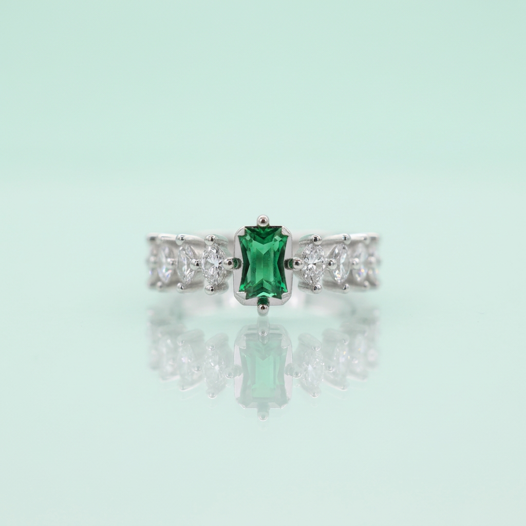 Real-world perspective showing a rectangular forest green emerald ring