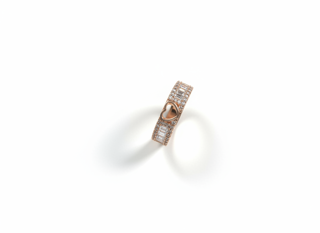 Clean studio flat lay of a sculptural rose gold heart ring with baguette frames resting on a smooth ceramic tile.