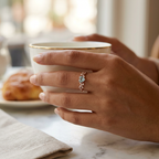 Close-up of a heart cut cerulean stone ring in rose gold plated sterling silver with lab grown diamonds.