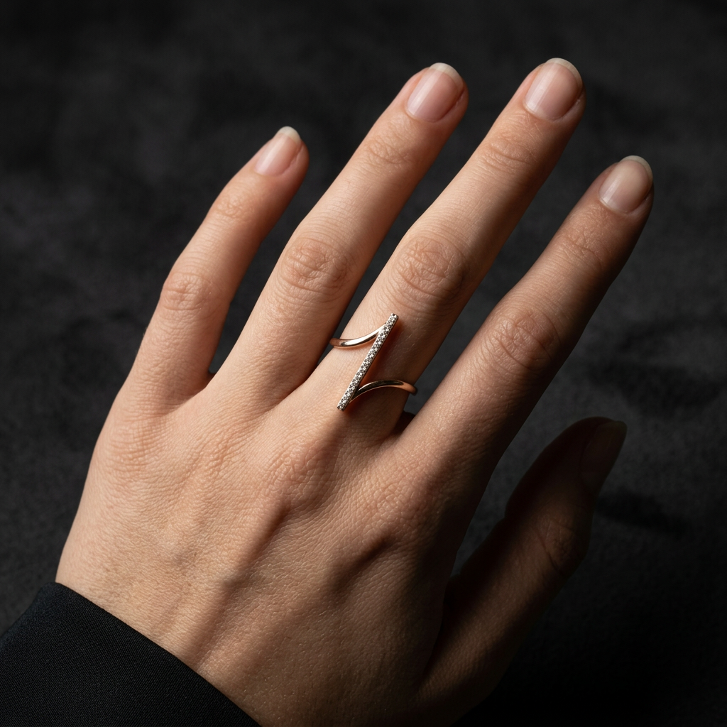 A women showcasing a kinetic gold axis ring, highlighting its clean geometric lines and orbital style.