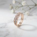 A delicate rose gold crown ring featuring a layered silhouette with alternating marquise and round diamonds.