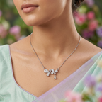 A delicate butterfly motif piece acting as a sophisticated, luminous anchor within a layered silver pear cut chain stack.
