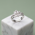 Front studio view of a silver celestial crown ring featuring a double band anchored by a cluster of marquise stones.