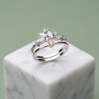 Front studio view of a silver celestial crown ring featuring a double band anchored by a cluster of marquise stones.