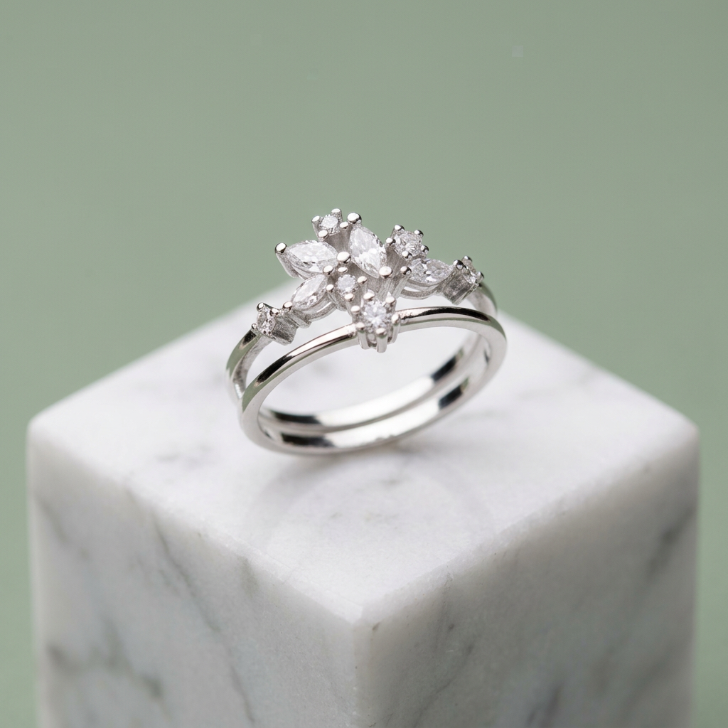 Front studio view of a silver celestial crown ring featuring a double band anchored by a cluster of marquise stones.