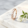 Front view of a rose gold baguette ring showcasing sharp crystals in an alternating diagonal architectural setting.