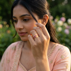 A curated fine jewelry stack featuring a brilliant red ruby eternity band paired with slim rose gold rings.