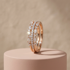 Architectural rose gold crown ring with symmetry-aligned marquise stones styled as a minimalist stack on a finger.