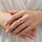 Front view of a wide rose gold heart ring framed by crisp baguette stones and fine pavé borders on a polished band.