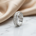Sterling silver layered ring fusing iridescent seed pearls, sharp baguette cuts, and brilliant micro set diamond accents.