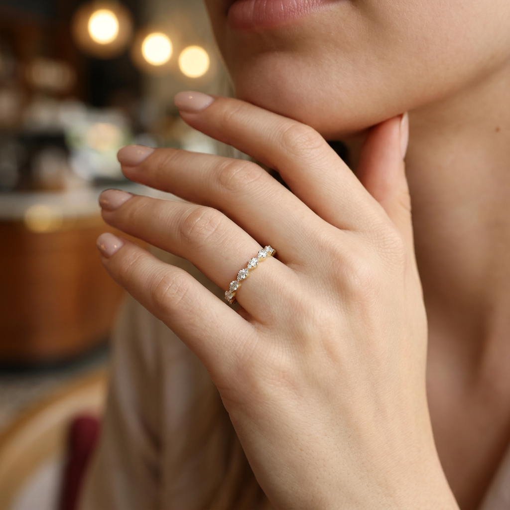 Close-up of an angular fine gold band ring showing precise serrated cuts and prong-set round diamonds.