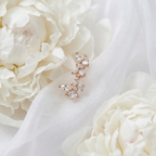 Macro shot zooming in on eye-shaped marquise stones set in delicate leaf-shaped gold prongs.