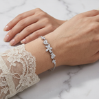 Lifestyle view of a woman wearing the Marquise Vine bracelet, demonstrating how the botanical sequence of marquise-cut lab grown diamonds looks layered and stacked on the wrist.