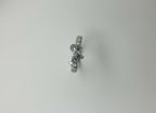 Top-down studio shot of a contemporary black enamel bow ring isolated cleanly on a smooth marble background.