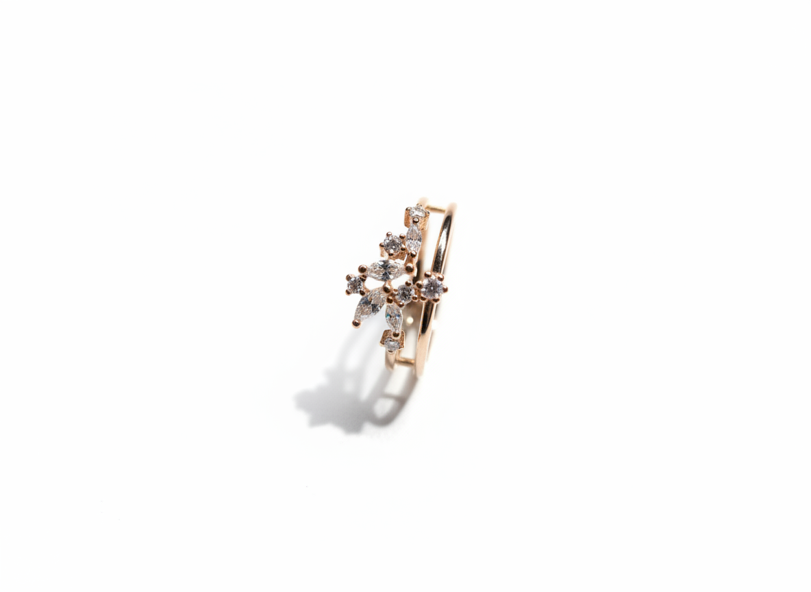 Studio flat lay of a geometric diamond cluster band in polished gold isolated cleanly on a warm marble plate.
