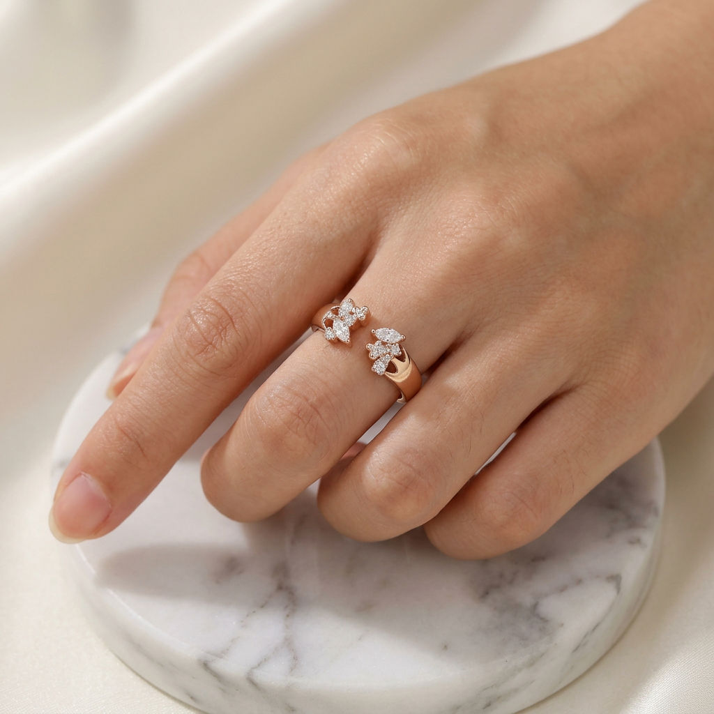 A woman wearing the delicate diamond ring on her finger, demonstrating how the open ring style layers.