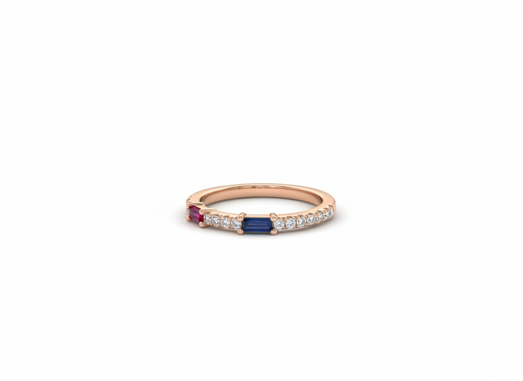High-fashion studio flat lay of an architectural rose gold ruby and sapphire ring resting on a smooth ceramic surface.