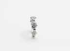Top-down studio shot of a modern geometric sculptural crystal cluster ring isolated on a premium marble tile.