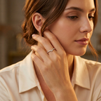 Symmetrical flat lay of a minimalist silver V band ring decorated with fine pavé stones on a clean textured surface.